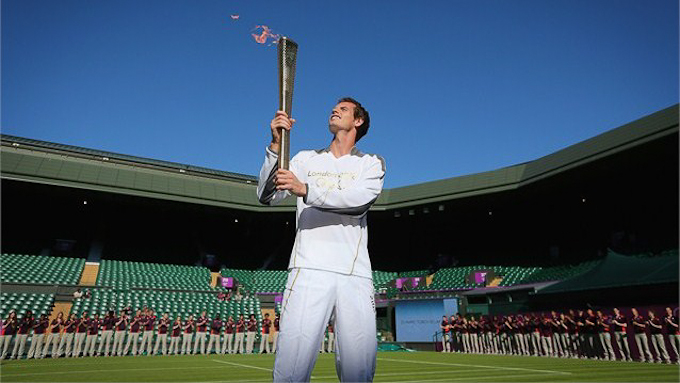 Andy Murray holds up the Olympic torch