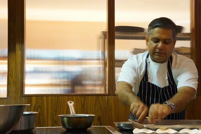 Cinnamon Kitchen Executive Chef, Vivek Singh, prepares a dish for his 'Curry for Change' menu.